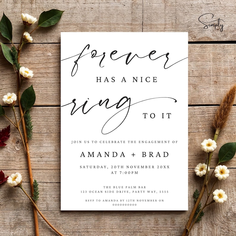 May include: White wedding invitation with black calligraphy text that reads "forever has a nice ring to it". The invitation announces the engagement of Amanda and Brad on Saturday, November 20th at 7:00 PM. The invitation includes the location of the event, The Blue Palm Bar, and RSVP information.
