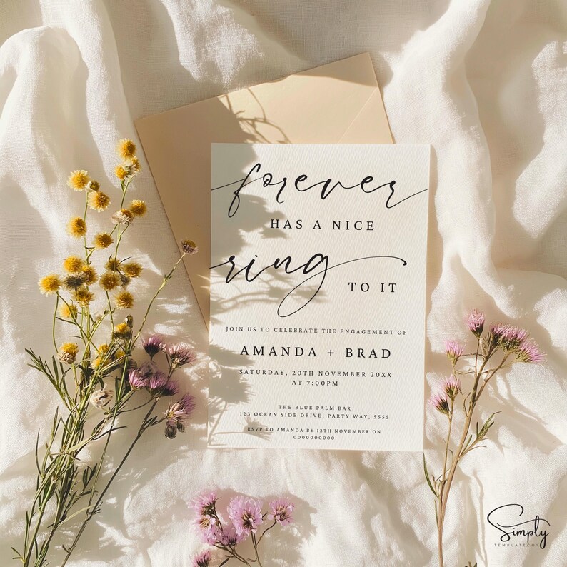 May include: A white card with black calligraphy that reads "forever has a nice ring to it". The card is an engagement announcement for Amanda and Brad, with the date and time of the event, as well as the location: The Blue Palm Bar, 123 Ocean Side Drive, Party Way, 5555. RSVP by 12th November on 0000000000.