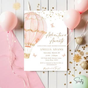 May include: A pink and gold baby shower invitation featuring a hot air balloon illustration. The text reads "Adventure Awaits" and includes the name Amelia Adams, the date and time of the event, and the location. RSVP information and registry details are also provided.