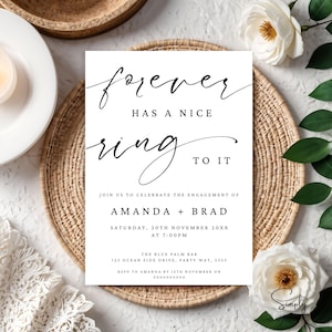 May include: A white card with black calligraphy that reads "forever has a nice ring to it". The card is an engagement announcement for Amanda and Brad, with the date and time of the event, the location, and RSVP information.