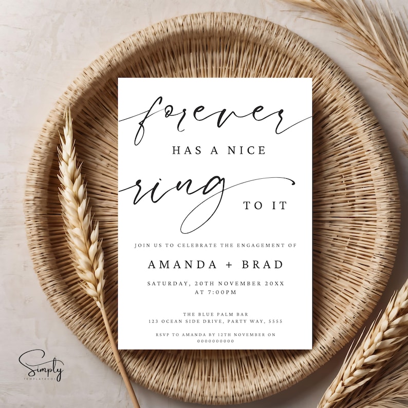 May include: A white wedding invitation with black calligraphy that reads "forever has a nice ring to it". The invitation announces the engagement of Amanda and Brad on Saturday, November 20th at 7:00 PM. The invitation includes the location and RSVP information.