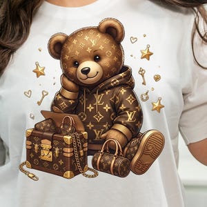 May include: A brown teddy bear wearing a brown hoodie and sneakers, with a matching suitcase and handbag. The bear is surrounded by gold stars, keys, and hearts. The bear and accessories feature a repeating pattern.