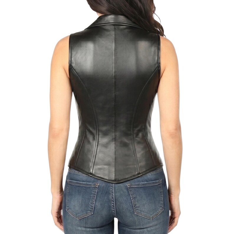 Woman wearing black genuine sheep leather corset vest made from soft real lambskin leather with front zipper, deep V-neck, gold studs and flap pockets, styled with blue jeans - edgy moto biker genuine leather top