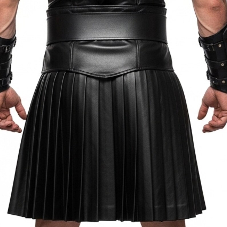 May include: Black leather kilt with pleated design. The kilt features a wide waistband and a knee-length hemline. The garment is made of a smooth, matte leather material.