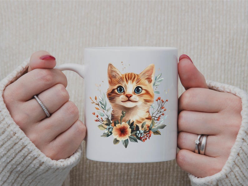 May include: White ceramic mug featuring a watercolor illustration of a ginger tabby cat with blue eyes, surrounded by floral elements. The cat's portrait is centered on the mug, creating a charming and artistic design.