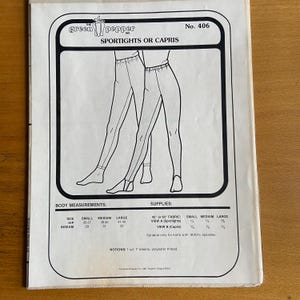 May include: A black and white line drawing of a pair of leggings and capris. The pattern includes measurements for small, medium, and large sizes. The text "green pepper" and "Sportights or Capris" is included in the image.