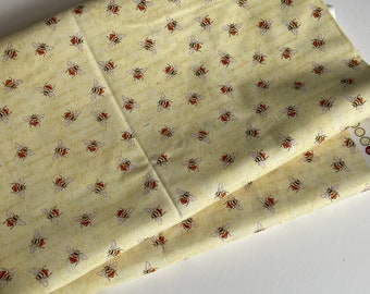 quilting cotton From The Garden sewing fabric Jane Maday Wilmington Yellow patterned background with words Bee toss Sold by yard x 44" wide
