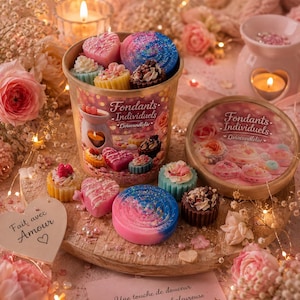 Peut inclure: Un récipient cylindrique en carton rempli de fondants parfumés en forme de cœurs, de cupcakes et de spirales, portant l'inscription Fondants Individuels Liviacandleliv. Le couvercle est posé à côté, arborant la même marque et des images de fondants.
