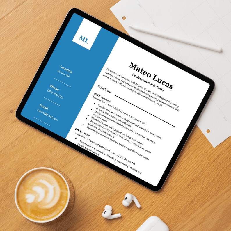May include: A digital tablet displays a resume with the name Mateo Lucas and the title Professional Job Title. The resume highlights woodworking experience. A cup of coffee and wireless earbuds are on the wooden surface.