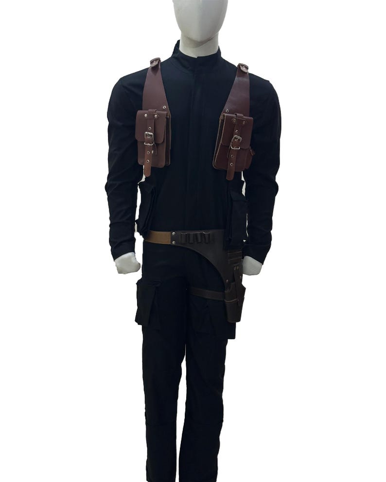 May include: Black jumpsuit with brown leather pouches and a belt. The costume includes a holster and a utility belt. The mannequin is wearing a long-sleeved black shirt and black pants. The pouches have buckles.