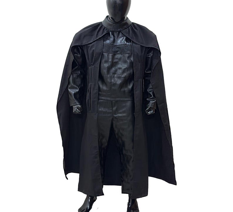 May include: A black hooded cloak with a long, flowing cape. The cloak is made of a soft, comfortable fabric and has a high collar. The cape is attached to the cloak at the shoulders and falls to the floor.