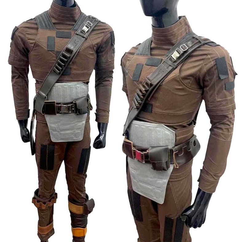 May include: Brown costume with a high collar, shoulder strap, and utility belt. The outfit includes a chest plate, leg armor, and gloves. The costume is displayed on a mannequin.