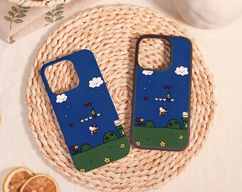 May include: Two dark blue phone cases featuring a pixelated landscape design with Hello Kitty characters, green grass, yellow flowers, red tulips, white clouds, and small red hearts scattered across a blue sky background.