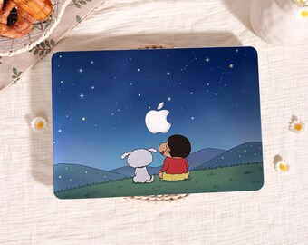 May include: A rectangular laptop skin featuring a dark blue night sky filled with stars. A cartoon character in a red shirt and yellow shorts sits on a green hill next to a white dog, both looking up at a glowing white Apple logo.