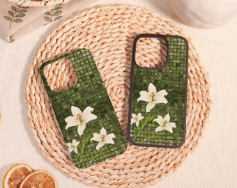 May include: Two rectangular phone cases featuring a dark green mosaic tile pattern background with white lily flowers. Each case has a black border and a cutout for the camera lens, displaying a consistent floral design across both items.