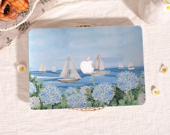 May include: A laptop hard shell case featuring a watercolour illustration of sailboats on a blue ocean under a light blue sky, with a cluster of light blue and white hydrangea flowers in the foreground and a cutout for the Apple logo.