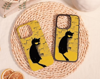 May include: Two phone cases featuring a black cat illustration against a yellow background with a stack of papers. One case has a yellow border, while the other has a black border. Both cases show the same cat graphic with yellow eyes.