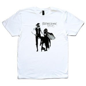 May include: White t-shirt featuring a black and white image of a couple dancing. The text "Fleetwood Mac Rumours" is printed above the image.
