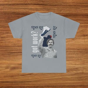 May include: Gray t-shirt with a graphic of a man holding a sneaker. The text "got work?" is printed vertically on the left side, with "FRENCH BLUE" above and below. The words "FRENCH BLUE" are also printed on the right side.