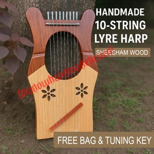May include: A handmade 10-string lyre harp crafted from sheesham wood. The instrument has a light brown body with a darker brown frame and floral cutouts. The text "HANDMADE 10-STRING LYRE HARP SHEESHAM WOOD" is visible. Includes a free bag and tuning key.