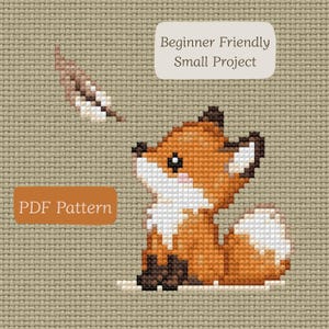 May include: A cross-stitch pattern on tan Aida cloth featuring a small orange fox with a white chest and tail tip, looking up at a floating brown feather. The image includes text boxes that read "Beginner Friendly Small Project" and "PDF Pattern."