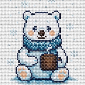 May include: Cross-stitch pattern of a polar bear holding a brown mug, wearing a blue scarf. The bear has a white body, light brown paws and cheeks, and a dark brown nose. Snowflakes are in the background.