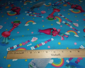 Trolls Poppy Cupcakes Rainbows Toss Blue Fabric Sold by Yard