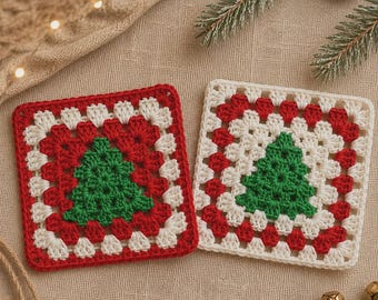 May include: Two square crochet coasters featuring a central green Christmas tree motif. One coaster has a red border with white accents, while the other has a white border with red accents. Both are crafted with a classic granny square pattern.