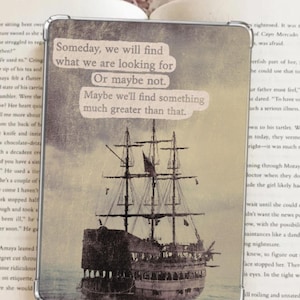 May include: A vintage-style phone case with a quote about finding what you are looking for. The quote reads "Someday, we will find what we are looking for. Or maybe not. Maybe we'll find something much greater than that." The background is a faded image of a ship sailing on the ocean.