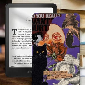 May include: An e-reader device displaying text on its screen, partially covered by a protective case featuring a purple collage. The collage includes a black cat, a red rose, a bat-winged figure, a sun face, and text reading: she loves moonlight and rainstorms and so many other things that have soul.