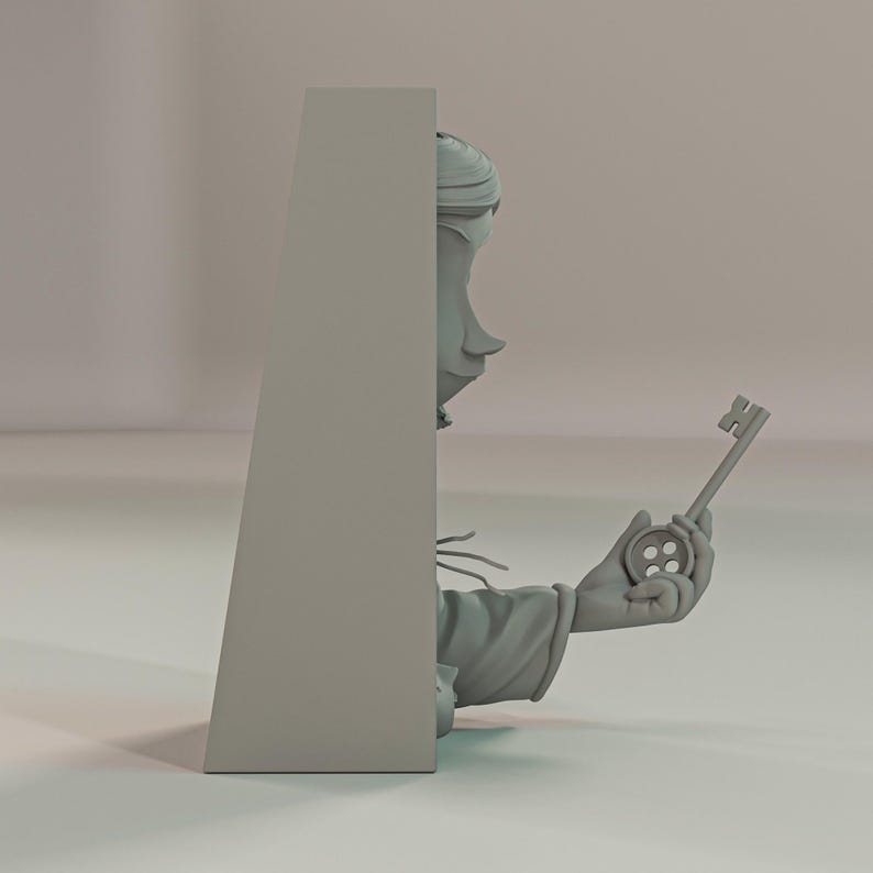 May include: A grey sculpture of a character holding a key with a button-shaped handle. The character is partially obscured by a grey rectangular structure. The sculpture has a whimsical, cartoonish style.