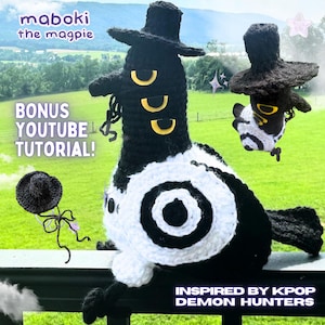 May include: A handmade crochet magpie doll with a black top hat, black and white body, and yellow accents. The text "maboki the magpie" and "BONUS YOUTUBE TUTORIAL!" are visible. The design is inspired by KPOP Demon Hunters.