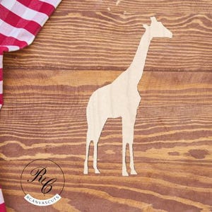 May include: A white wooden cutout of a giraffe on a brown wooden background. The giraffe is standing with its head held high and its neck stretched out.