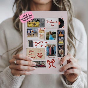 May include: A light pink photo album with various pictures and decorative elements. The album features a digital camera, a vinyl record, playing cards, and the text "Volume 16". The cover also includes the text "Up to 11 Personalized Pictures!!!".