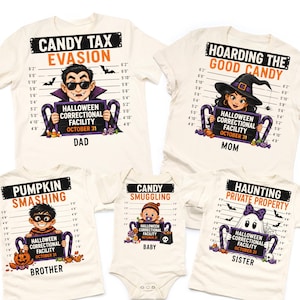 May include: A set of five off-white shirts and a baby bodysuit featuring Halloween-themed mugshot graphics. Each garment displays a character holding a sign reading Halloween Correctional Facility October 31 against a height chart background.