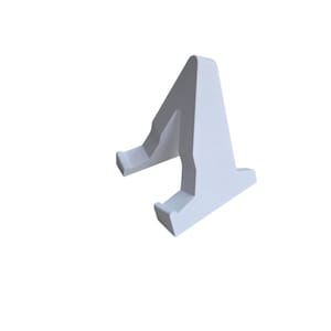 May include: A white, angled phone stand with a textured cradle. The stand is designed to hold a phone or tablet upright. The stand has a simple, modern design and is made of a solid, opaque material.