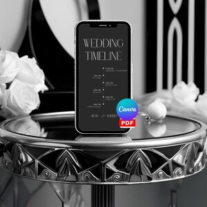 May include: A black and white wedding timeline on a smartphone screen. The timeline includes the wedding ceremony, reception, dinner, and first dance. The screen is on a black and silver table.