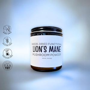 May include: A jar of freeze-dried Lion's Mane mushroom powder. The label includes the text "FREEZE-DRIED FUNCTIONAL LION'S MANE MUSHROOM POWDER". The jar is labeled as non-GMO, gluten-free, and pesticide-free. Net wt. 1.5oz (42g).