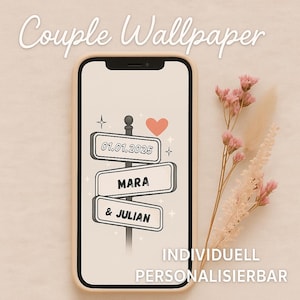 May include: A phone displaying a custom couple's wallpaper with a signpost design. The signpost features the date 01.01.2025, the names Mara & Julian, and a heart icon. The phone is in a beige case, with the words "Couple Wallpaper" at the top.