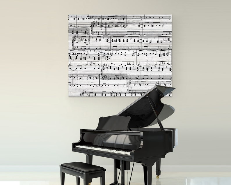 May include: A black grand piano with a matching bench sits in front of a wall. Above the piano is a square canvas print featuring a black and white musical score. The piano's keys are visible.