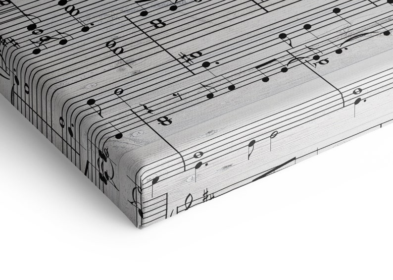 May include: A canvas print featuring a close-up of musical notes and symbols. The black notes are set against a light gray, wood-grain background. The print has rounded corners and a white border.