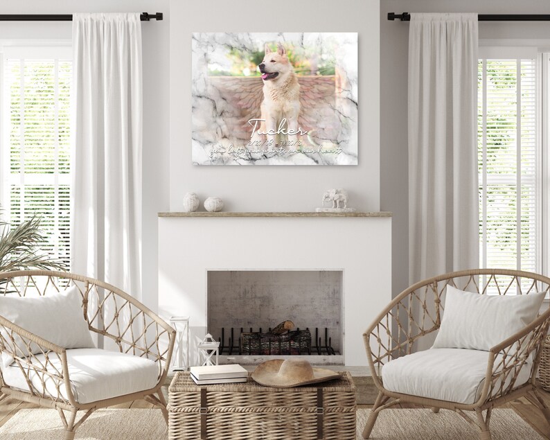 May include: A white marble-textured memorial print with a photo of a white dog with brown markings. The dog is standing on a wooden surface. The text "Tucker" is written in a white cursive font with a white heart and the dates "2012 - 2023" below the name.
