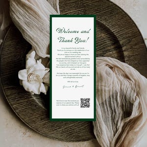 May include: A wedding welcome sign with a dark green border and elegant script. The sign reads "Welcome and Thank You!" and includes a message of gratitude, along with the names "Sienna & Bennet". A QR code is included.