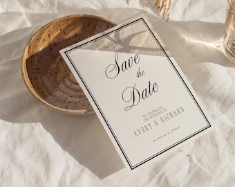 May include: A cream-colored "Save the Date" card with black text and a black border. The card reads "Save the Date" and includes the names Avery & Richard. A rustic bowl sits to the left.