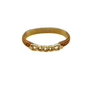 May include: A gold chain bracelet with a brown leather band. The bracelet is a simple design with a classic look.