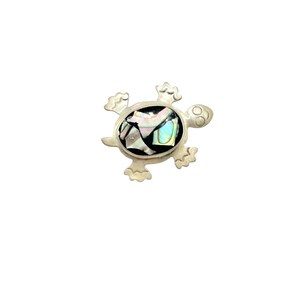 May include: A silver turtle pendant with a black background and iridescent abalone shell inlay.