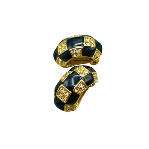 May include: A pair of black and gold clip-on earrings with a checkered pattern and clear rhinestones.