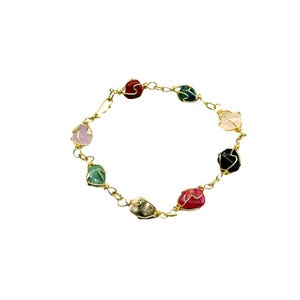 May include: A gold wire wrapped bracelet with eight different colored stones. The stones are pink, red, green, black, white, and a mix of green and white.
