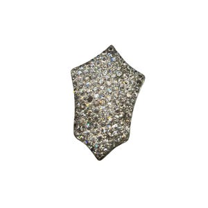 May include: A silver ring with a large, faceted, star-shaped stone set with smaller diamonds.
