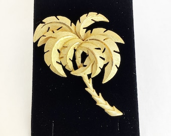 Palm tree brooch tropical vacation pin in a gold tone textured vintage costume jewelry